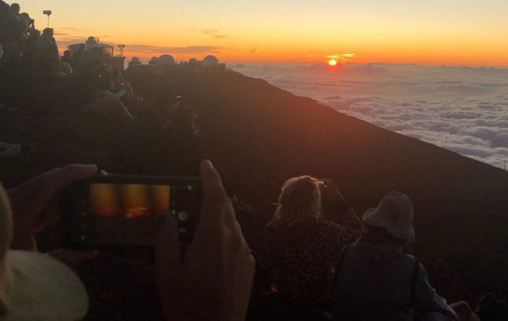 Visitors waiting for sunset at the summit