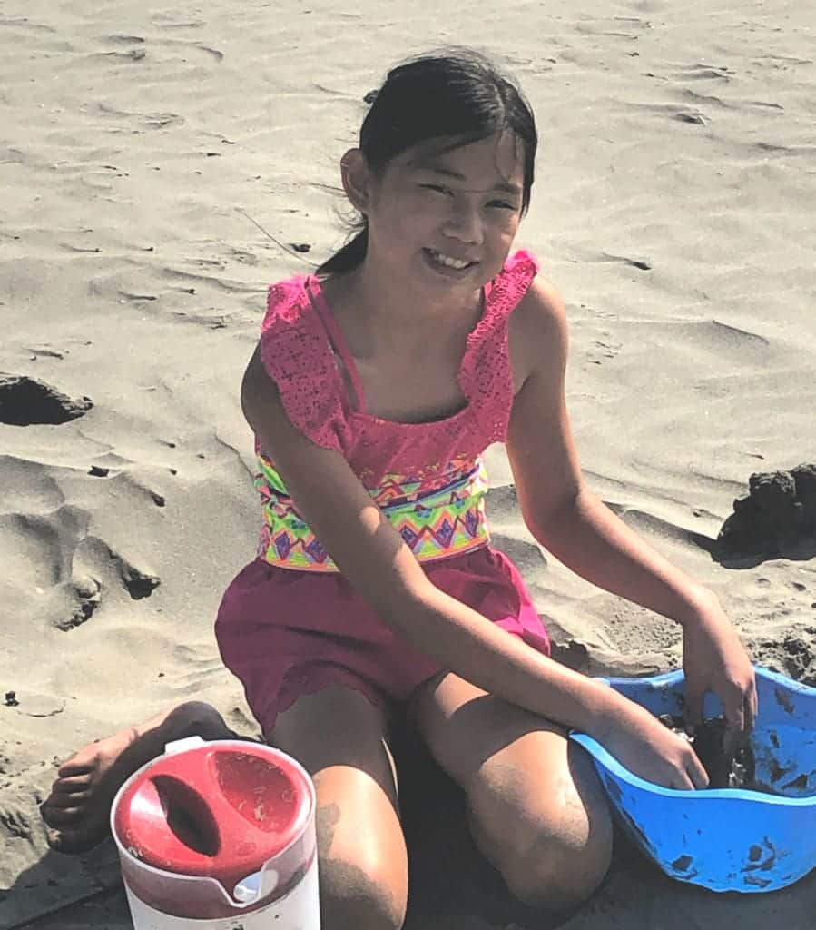 Sophia relaxing at the beach while we avoid the crowds on vacation