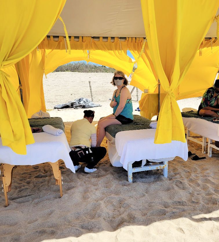 Massage therapist cleaning the sand off my feet as I got ready for my first massage on the beach