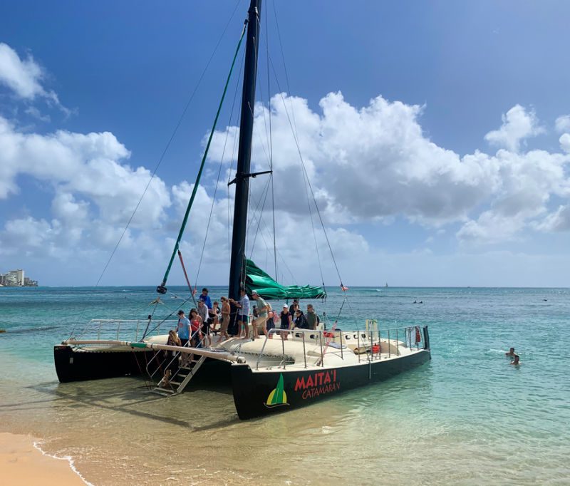 Families taking a cruise on a catamaran in Oahu 