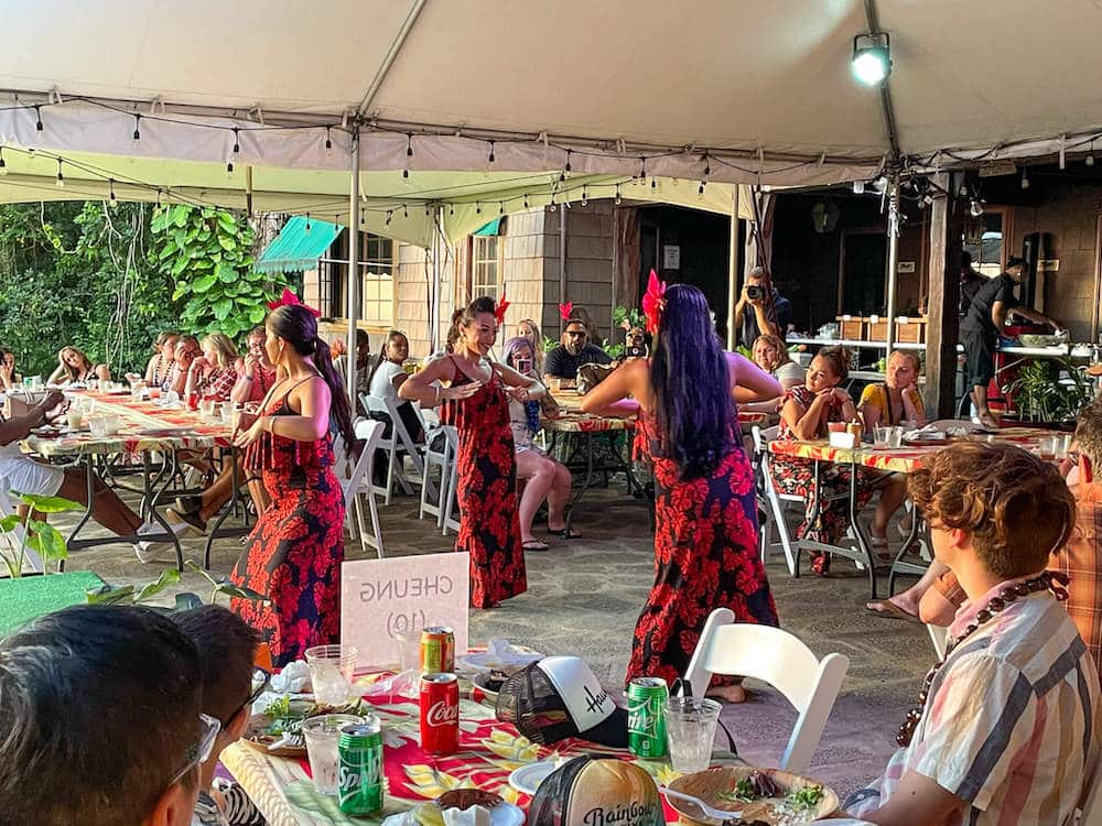 Woman entertain the crowd with a traditional Hawaiian dance at the Experience Nutridge Luau in Oahu