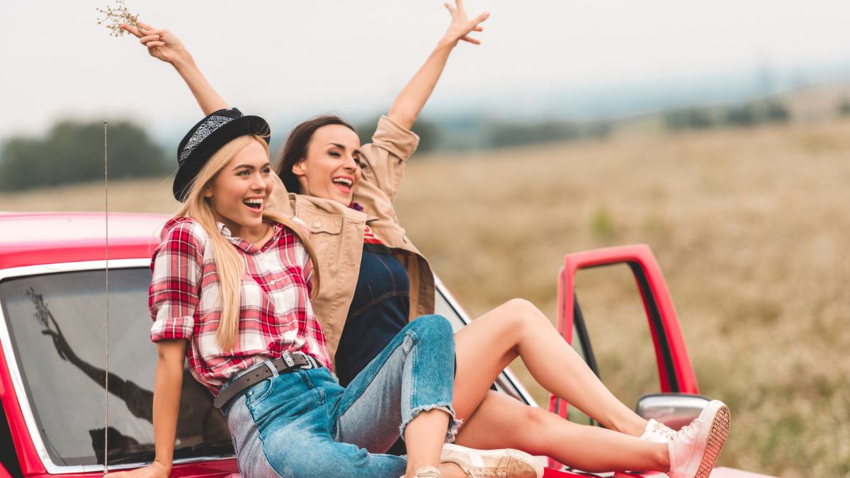 two girls sitting on red truck