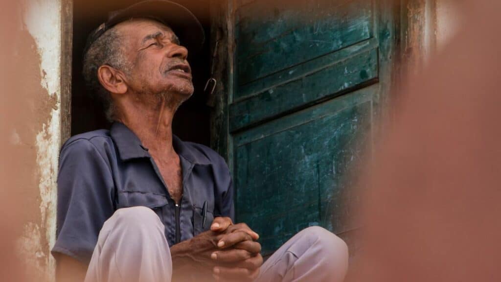 older man sitting in doorway