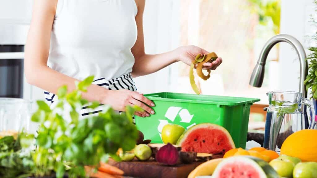 woman in kitchen with recylce bin