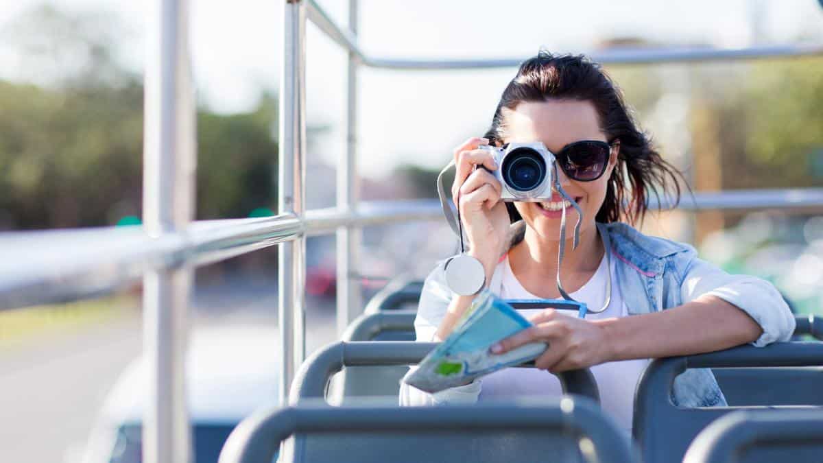 woman on open top tour bus