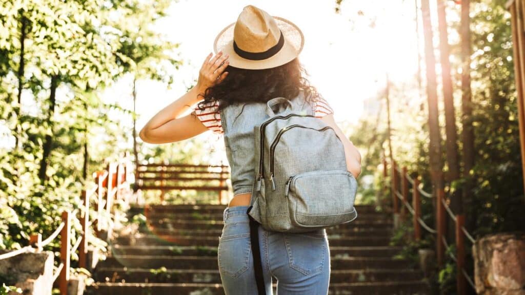 woman with backpack on stairs
