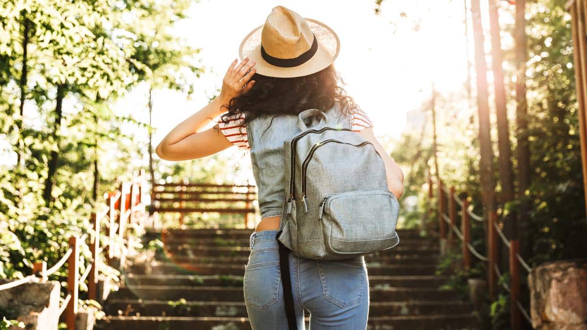 woman with backpack on stairs