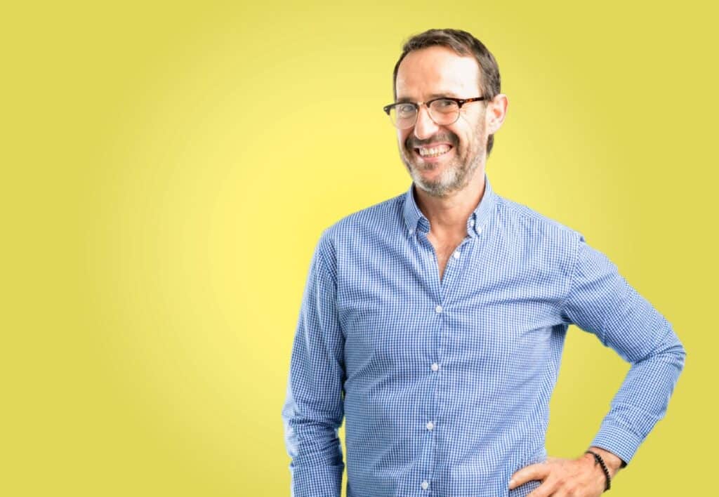 Handsome middle age man confident and happy with a big natural smile laughing