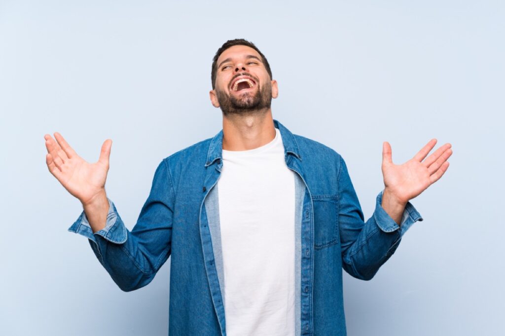 Handsome man Dad over isolated blue background smiling a lot