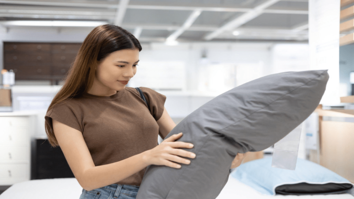 chanakon-laorob-Young-beautiful-woman-choosing-pillow-at-retail-furniture-store.png