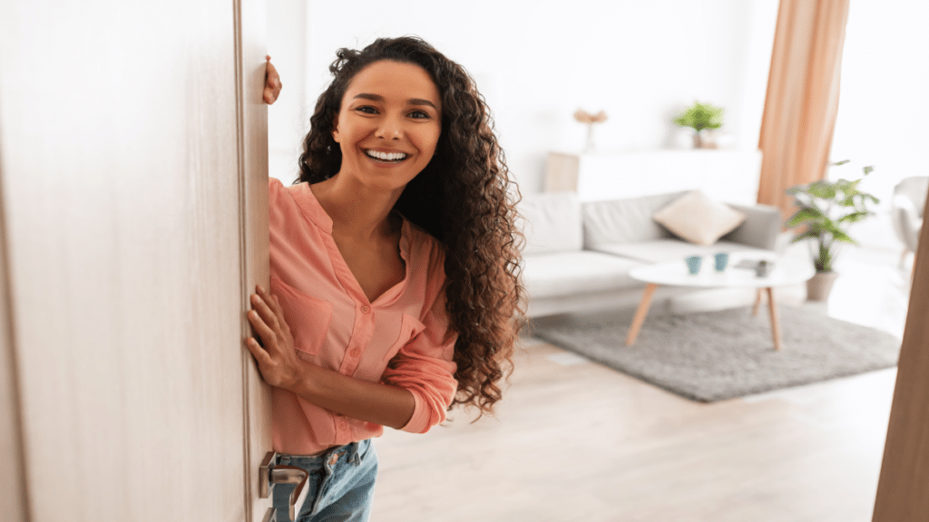 young lady holding door